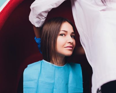 Portrait of young woman visiting dentist office for teeth whitening with photopolymer